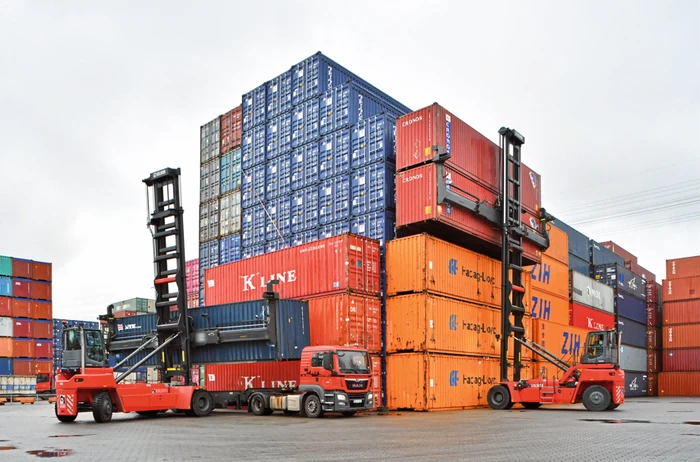 Two empty container handlers stacking multi-tier ISO containers at port depot1 Two empty container handlers stacking multi-tier ISO containers at port depot1