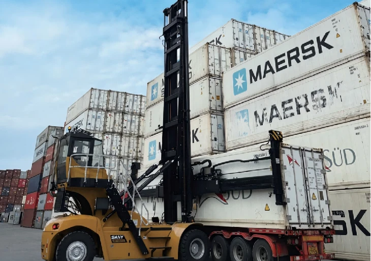 Empty container handler loading empty container onto container truck1 Empty container handler loading empty container onto container truck1