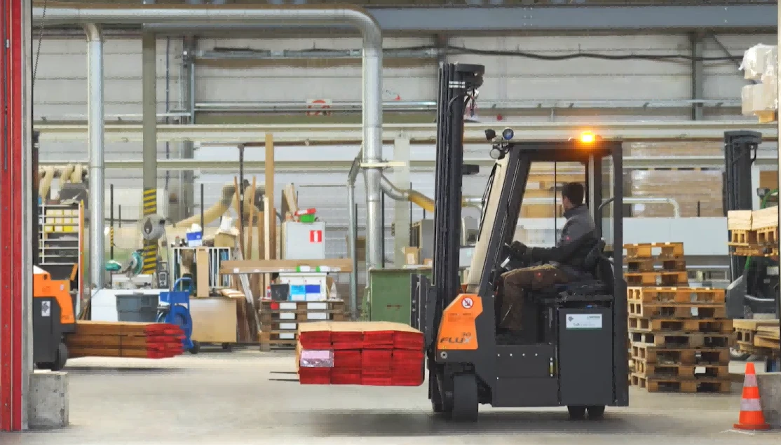 Electric forklift transporting pallet goods inside distribution warehouse1 Electric forklift transporting pallet goods inside distribution warehouse1