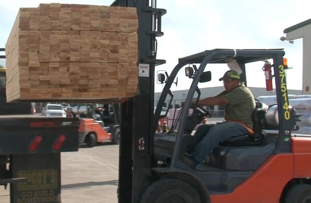 LPG forklift transporting long lumber materials on outdoor yard1 LPG forklift transporting long lumber materials on outdoor yard1