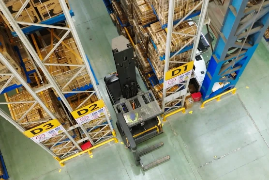 High-bay reach truck operating inside multilevel pallet rack warehouse1 High-bay reach truck operating inside multilevel pallet rack warehouse1
