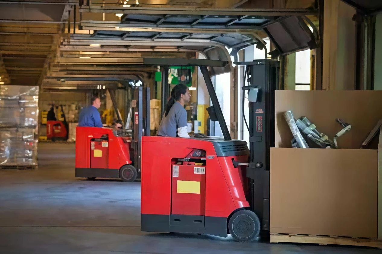 Multiple electric forklifts preparing for daily preshift inspection inside distribution warehouse1 Multiple electric forklifts preparing for daily preshift inspection inside distribution warehouse1
