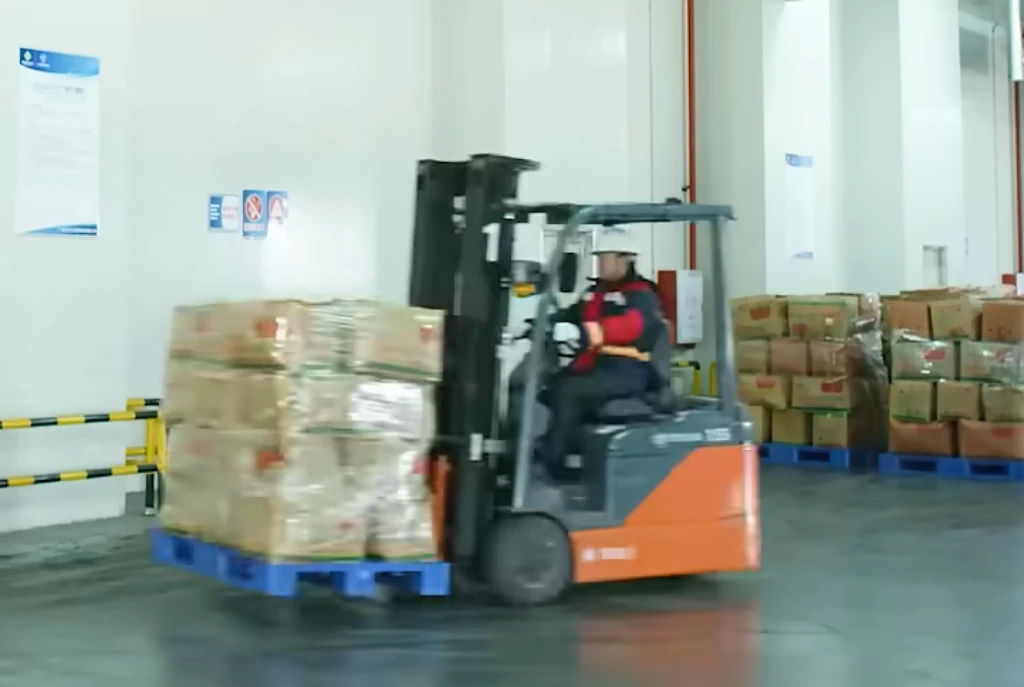 Lithiumion electric forklift running heavycycle handling inside general warehouse Lithiumion electric forklift running heavycycle handling inside general warehouse